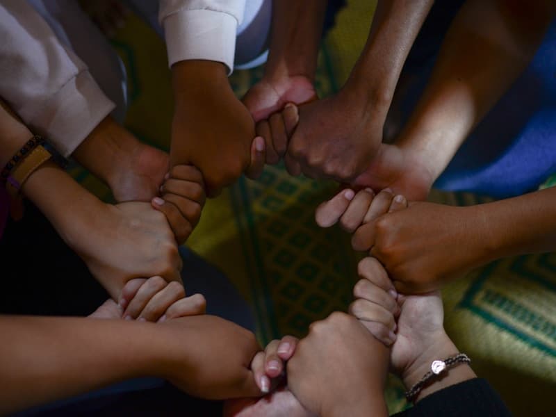 Community support and unity - hands reaching out in fellowship